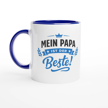 Grafisches Design für eine Tasse: Schriftzug 'Mein Papa ist der Beste!' in Blau und Schwarz. Über dem Text ist eine kleine blaue Krone abgebildet, links und rechts befinden sich stilisierte blaue Lorbeerzweige. Der Stil ist modernes Lettering auf weißem Hintergrund.
