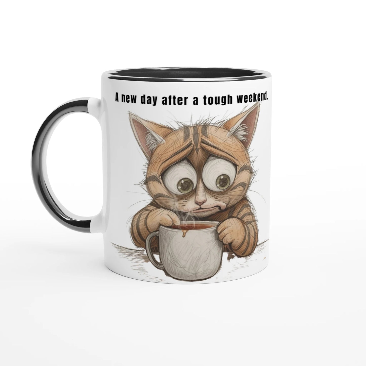 Eine weiße Tasse mit schwarzem Henkel und Innenrand. Die Illustration zeigt eine erschöpfte, braun getigerte Katze mit riesigen, müden Augen, die sich krampfhaft an einer dampfenden Kaffeetasse festhält. Über der Grafik steht der Text: „A new day after a tough weekend.“.